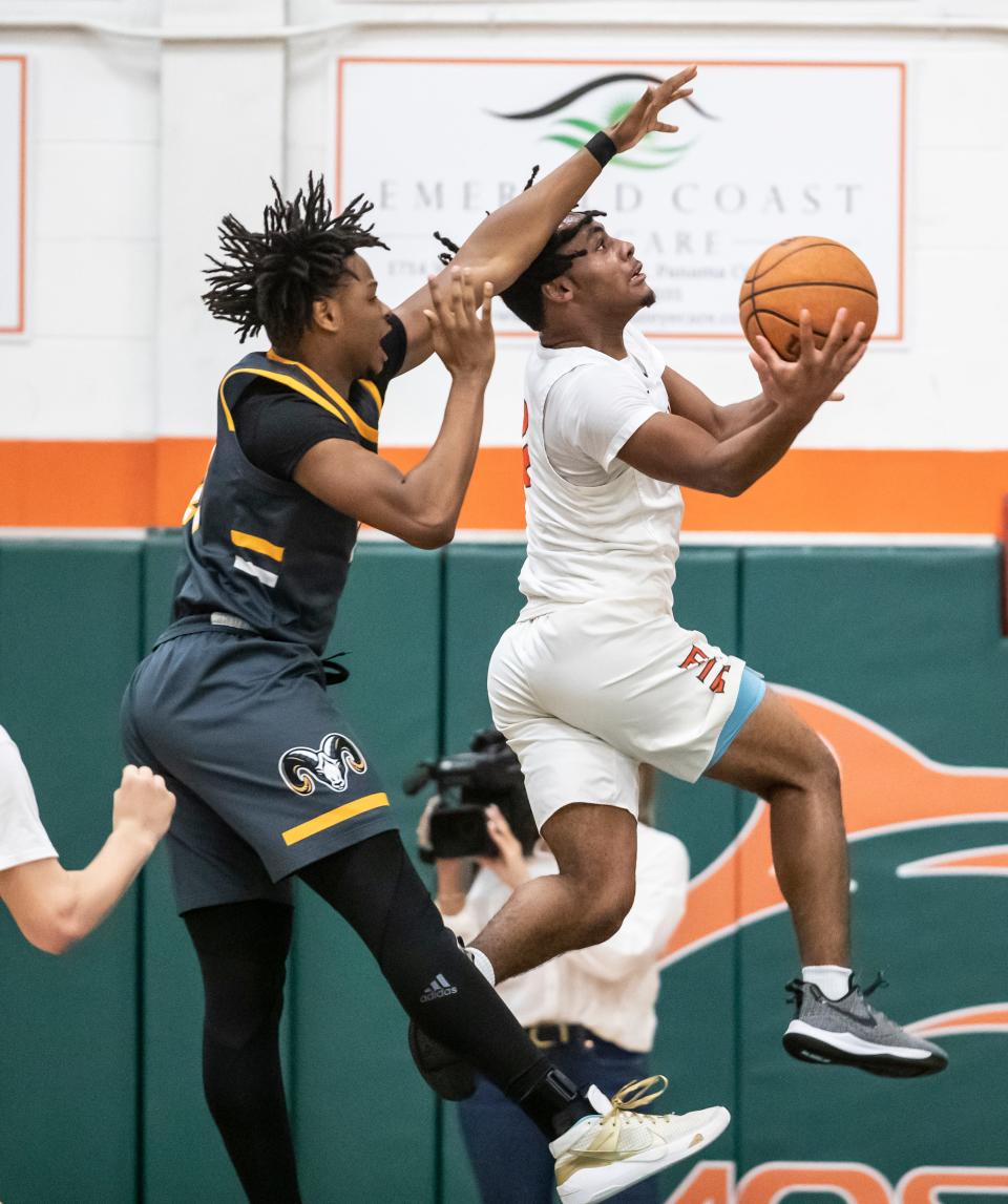 Mosley senior Josiah McCall drives the baseline with Rutherford senior Cedric Bland in pursuit. Mosley hosted Rutherford in boys basketball Friday, January 21, 2022.