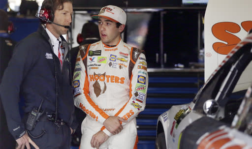 Chase Elliott, right, talks to a crew member in the garage during a practice session for Sunday’s NASCAR Cup series auto race at Texas Motor Speedway in Fort Worth, Texas, Friday, Nov. 3, 2017. (AP Photo/LM Otero)