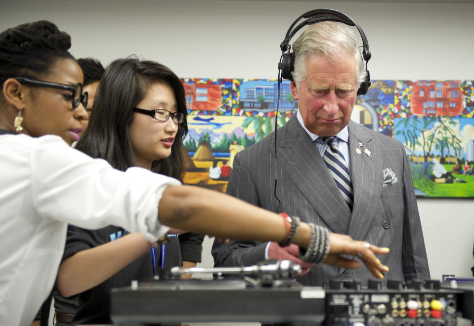 A puzzled Prince Charles learns how to scratch and fade on a turntable as he tours an employment skills workshop during a four-day visit to Canada to mark the Queen's Diamond Jubilee.