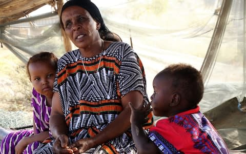 Fusia Muhammed Diriyie and her family are caretakers of a garden owned by a minister - Credit: Susan Schulman