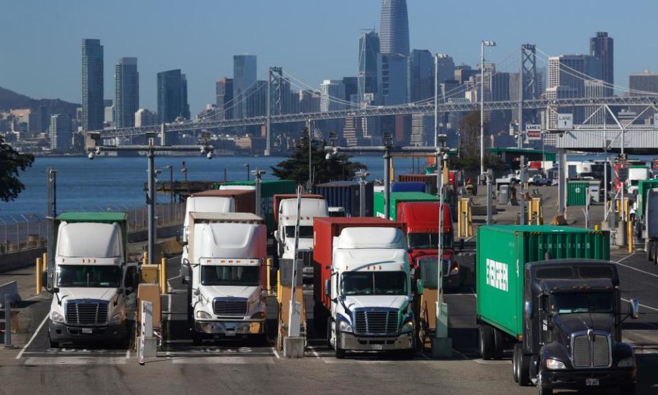 Trucks hauling shipping containers leave the EverPort terminal at the Port of Oakland in Oakland, California.