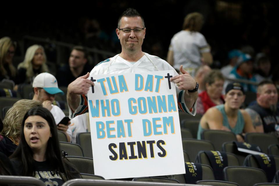 A Dolphins fan holds a sign before the Monday Night Football game between the Miami Dolphins and New Orleans Saints in the Superdome.