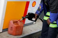 FILE PHOTO: A person fills a fuel container at a Shell gas station, after a cyberattack crippled the biggest fuel pipeline in the country, run by Colonial Pipeline, in Washington, D.C.