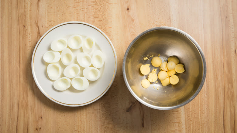 separated boiled eggs in dishes 