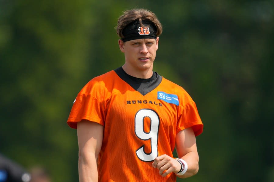 FILE - Cincinnati Bengals quarterback Joe Burrow (9) takes part in a drill during practice at the team's NFL football training facility, Tuesday, June 6, 2023, in Cincinnati. Burrow has reported to training camp amid negotiations for a long-term contract with the team that's expected to make him one of the NFL's highest paid players.(AP Photo/Jeff Dean, File)