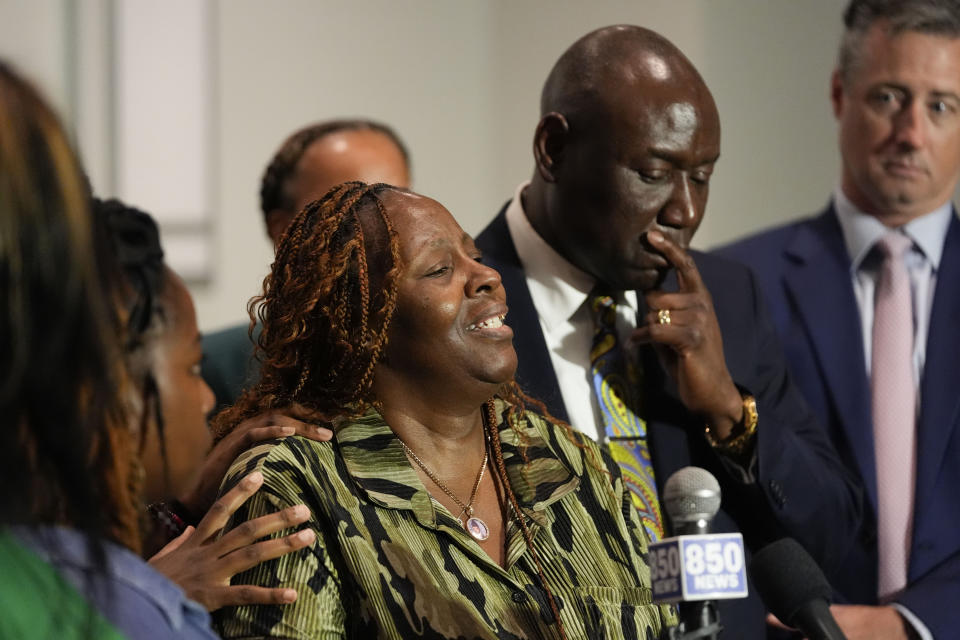 Chantemekki Fortson, mother of Roger Fortson, a U.S. Navy airman, speaks about her son during a news conference regarding his death, with Attorney Ben Crump, right, and attorney Brian Barr, far right. Thursday, May 9, 2024, in Fort Walton Beach, Fla. Fortson was shot and killed by police in his apartment on May 3, 2024. (AP Photo/Gerald Herbert)