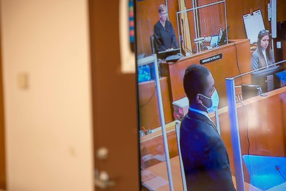 A video screen in a viewing room of the Bergen County Courthouse displays the trial of Lexie Burke in the courtroom of Judge Margaret Foti on Tuesday, Feb. 15, 2022. Burke stands at the start of the trial. He is one of four men involved in a botched Fairview drug deal that left one dead.