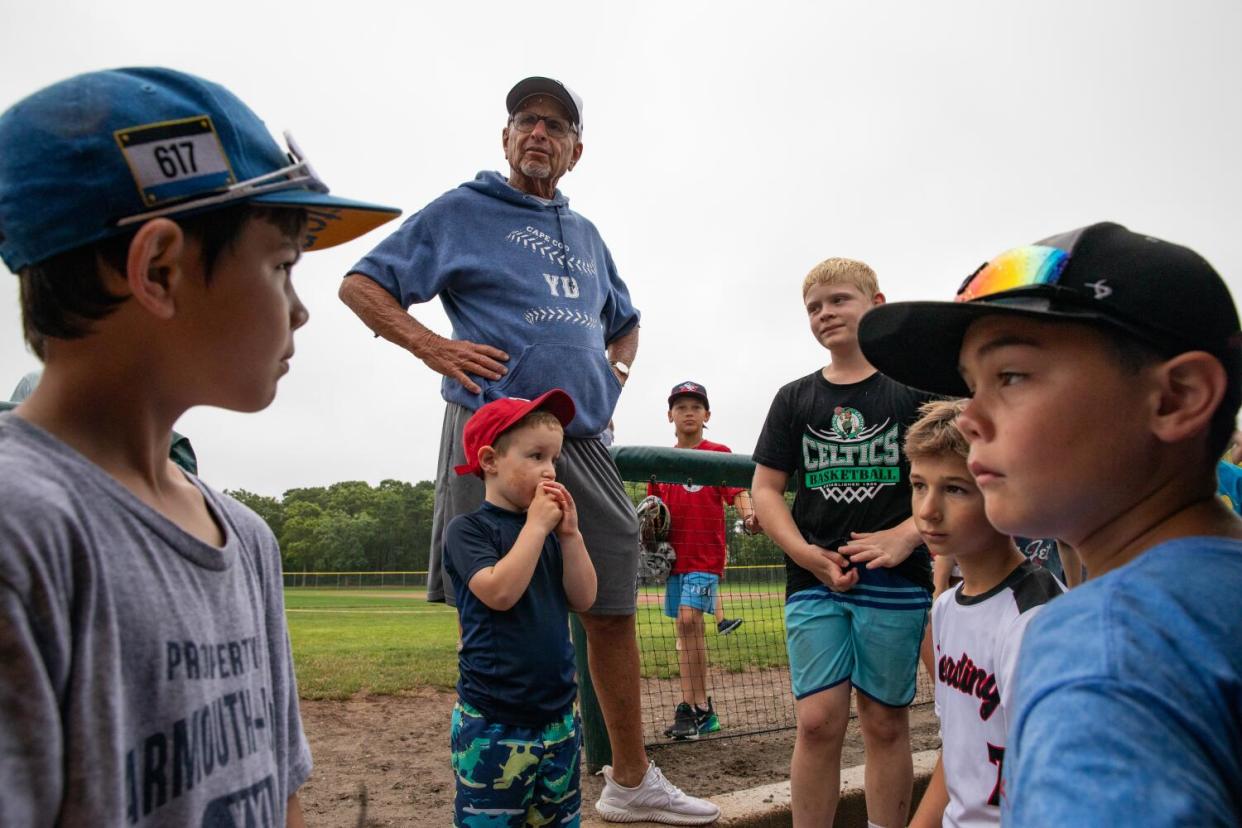 Coach Scott Pickler talks to young baseball players.