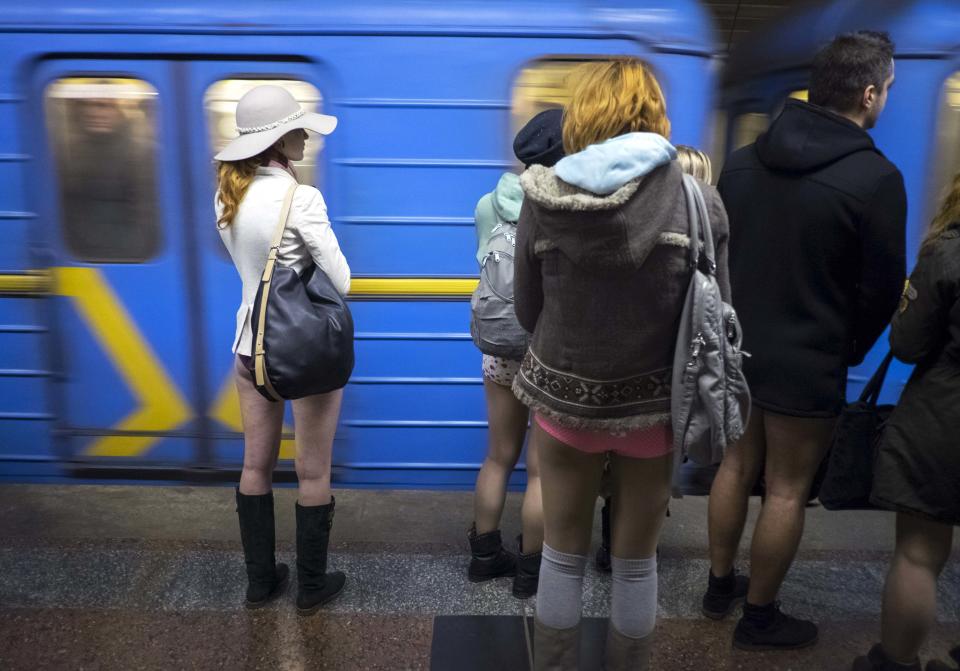 Passengers without pants wait on a underground platform during the "No Pants Subway Ride" in Kiev