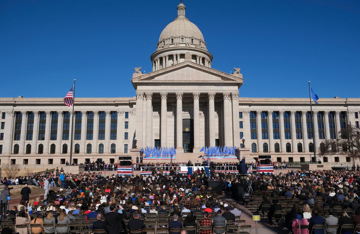 Chief Justice M. John Kane IV administers the oath of office to Gov. Kevin Stitt with his wife, Sarah, by his side on Monday.