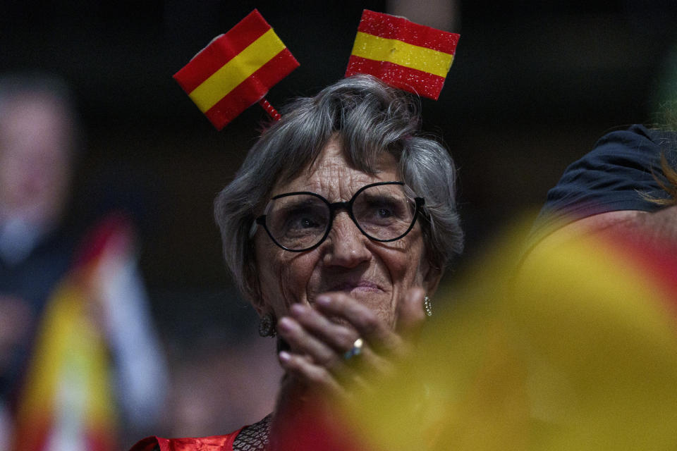 A supporter with a Spanish flags in her head takes part during the Spanish far-right wing party Vox's rally "Europa Viva 24" in Madrid, Spain, Sunday, May 19, 2024. VOX has invited speakers from across the right wing spectrum including Marine Le Pen, Viktor Orban and Argentine President Javier Milei who has been visiting Spain since Friday. (AP Photo/Manu Fernandez)