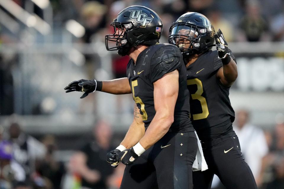 UCF Knights running back Isaiah Bowser (5) and UCF Knights wide receiver Xavier Townsend (3) celebrate a touchdown run by Bowser in the fourth quarter during a college football game against the Cincinnati Bearcats, Saturday, Oct. 29, 2022, at FBC Mortgage Stadium in Orlando, Fla. The UCF Knights defeated the Cincinnati Bearcats, 25-21. 