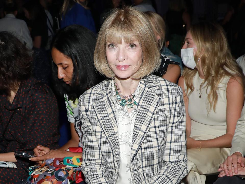 Anna Wintour attends the Proenza Schouler fashion show in a trench coat and dress in September 2022.