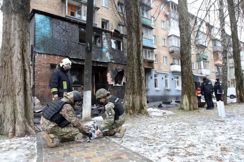 Law enforcement officers, explosive experts and rescuers work work at the site where Russian missile debris fell. --/Ukrinform/dpa