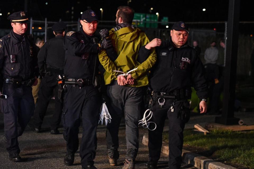 Police arrest an activist with Extinction Rebellion after the group protested at the New York Times printing press (Getty Images)