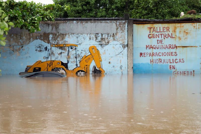 Submerged car is pictured outside a garage at an area flooded by Chamelecon river after the passing of Storm Iota, in La Lima