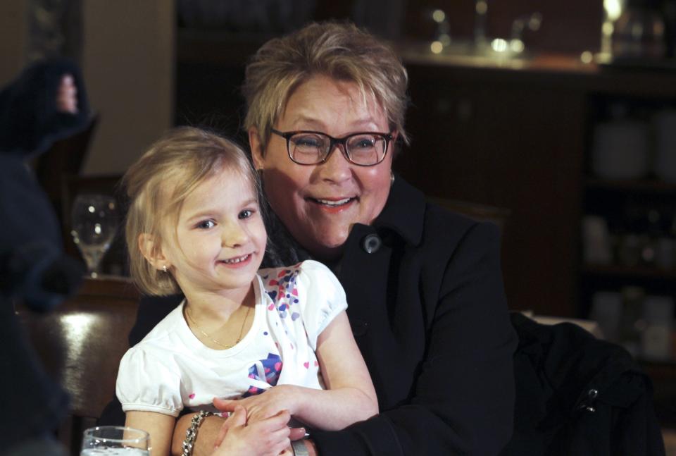 Parti Quebecois leader Pauline Marois embraces with a girl during a campaign stop in Blainville, Quebec, March 7, 2014. Quebec voters will go to the polls in a provincial election on April 7. REUTERS/Christinne Muschi (CANADA - Tags: POLITICS ELECTIONS)