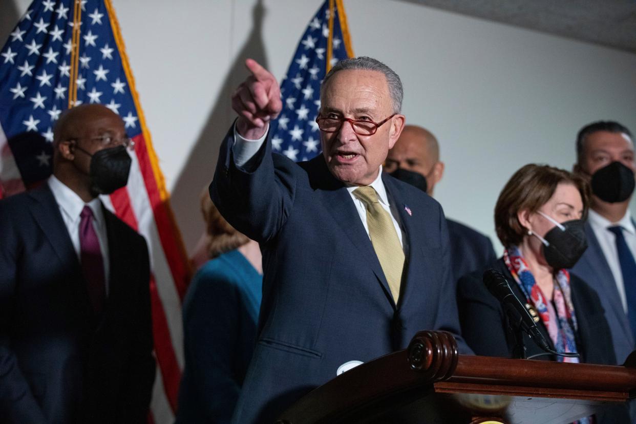 Senate Majority Leader Chuck Schumer (D-N.Y.) speaks to reporters alongside during a press conference regarding the Democratic party's shift to focus on voting rights at the Capitol in Washington, Tuesday, Jan. 18, 2022.