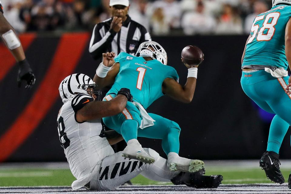 Bengals defensive tackle Josh Tupou sacks Dolphins quarterback Tua Tagovailoa and slams him to the ground during Thursday night's game in Cincinnati, Ohio.