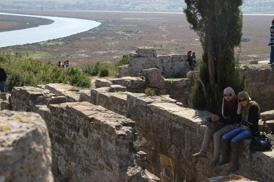 In this March 11, 2012 photo, Moroccan college students sit in the shade at the Roman ruins of Lixus in the north of the country. (AP Photo/Paul Schemm)