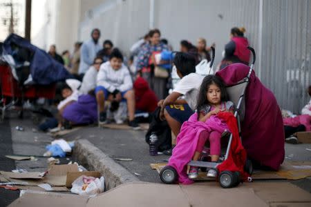 People wait in line at the Fred Jordan Mission annual back to school giveaway of shoes, clothing and backpacks for more than 4,000 homeless and underprivileged children in Los Angeles, California, United States, in this October 1, 2015, file photo. REUTERS/Lucy Nicholson/Files