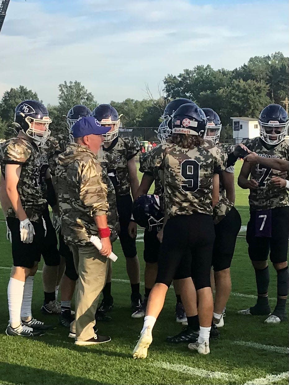 Mount Gilead head football coach Mike Reid meets with his team before kickoff during a home game with Elgin earlier this season. The Indians are going for their best season since 2004.
