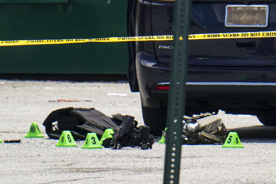 FILE - Body armor and evidence markers rest on the tarmac by a minivan near a mall parking area where two Baltimore city police officers were shot and a suspect was killed as a U.S. Marshals' task force served a warrant, Tuesday, July 13, 2021, in Baltimore, Md. When a shooter attacked a supermarket in Buffalo, New York, May 14, 2022, its security guard tried to stop him. At least one of the guard's shots hit the gunman, but it didn’t stop the deadly rampage because the gunman was wearing body armor. (AP Photo/Julio Cortez, File)