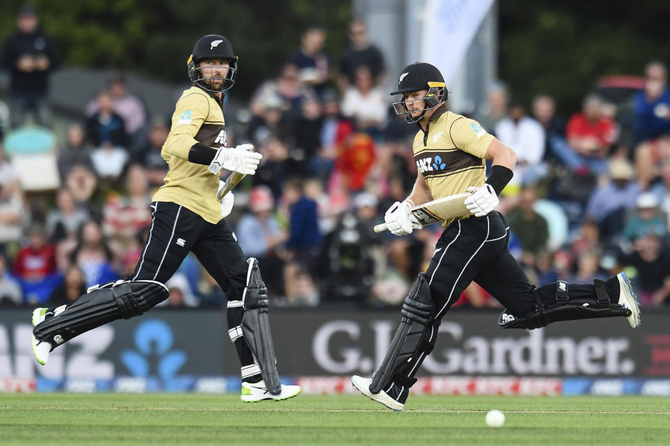 FILE - In this Feb. 22, 2021 file photo, New Zealand's Glenn Phillips, right, and Devon Conway run between the wickets during the first T20 cricket international between Australia and New Zealand at Hagley Oval in Christchurch, New Zealand. Phillips has been included for the first time on New Zealand Cricket's list of centrally contracted players. (John Davidson/Photosport via AP, File)