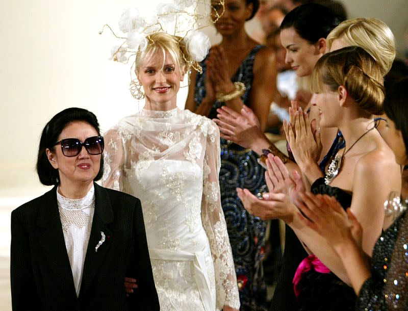 FILE PHOTO: Models applaud Japanese designer Hanae Mori (L) at the end of her Haute Couture 2003-2004 Autumn-Win..