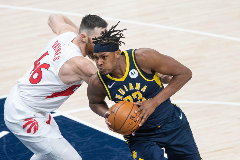 Jan 25, 2021; Indianapolis, Indiana, USA; Indiana Pacers center Myles Turner (33) moves to shoot the ball while Toronto Raptors center Aron Baynes (46) defends in the second quarter at Bankers Life Fieldhouse. 