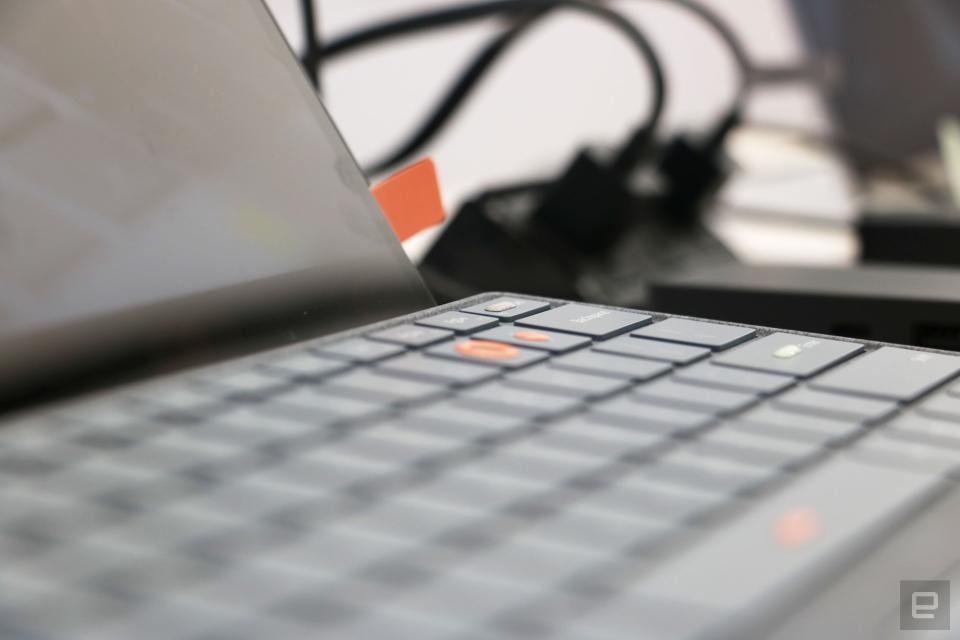 <p>A close up of two orange stickers from the Surface Adaptive Kit on a keyboard, showing the slight bump they create.</p>
