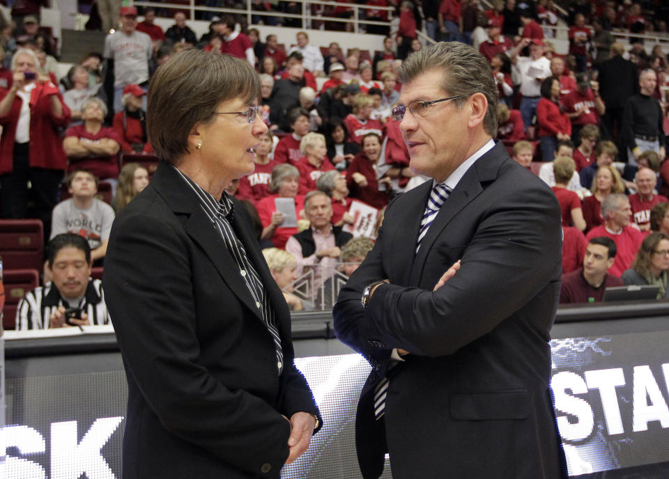 FILE - Connecticut head coach Geno Auriemma, right, talks with Stanford head coach Tara VanDerveer, left, before an NCAA college basketball game in Stanford, Calif., Dec. 29, 2012. Stanford coach VanDerveer can become college basketball's all-time wins leader this week when the Cardinal face Oregon and Oregon State at home. (AP Photo/Tony Avelar, File)