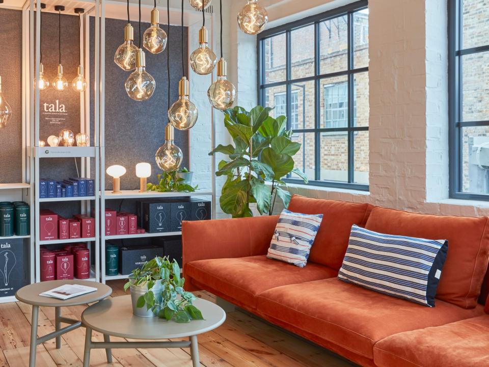 Lighting display at Tala Studios with an orange sofa.