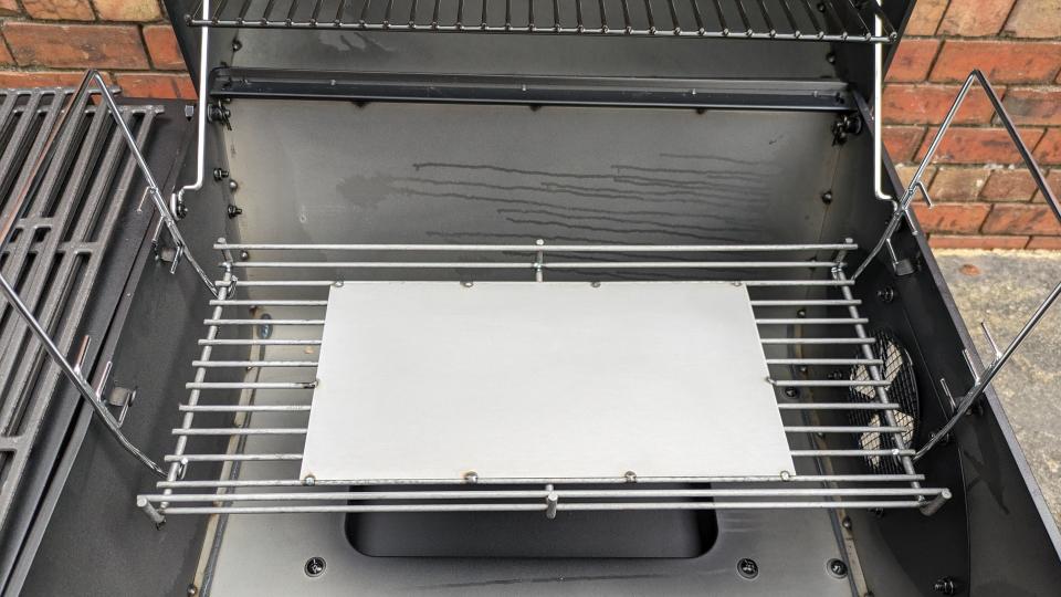 The charcoal grate can be raised or lowered with a tool to fine-tune cooking performance.