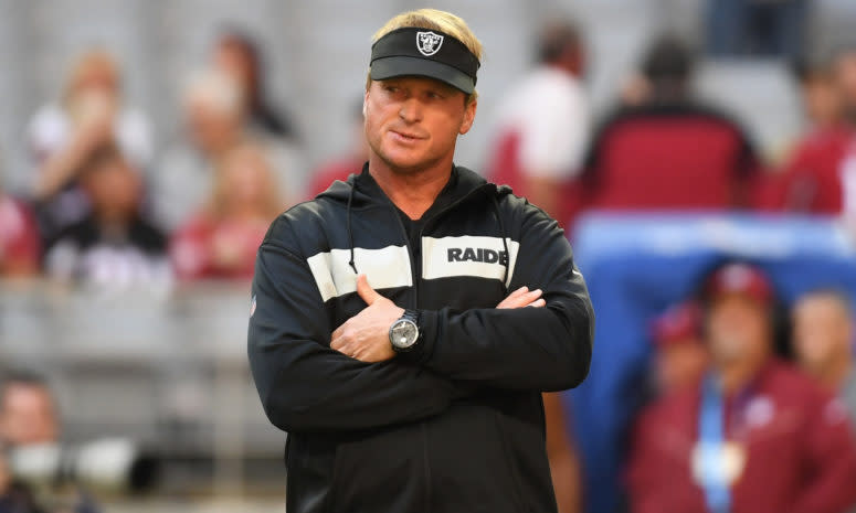 A closeup of Oakland Raiders coach Jon Gruden wearing a black visor.