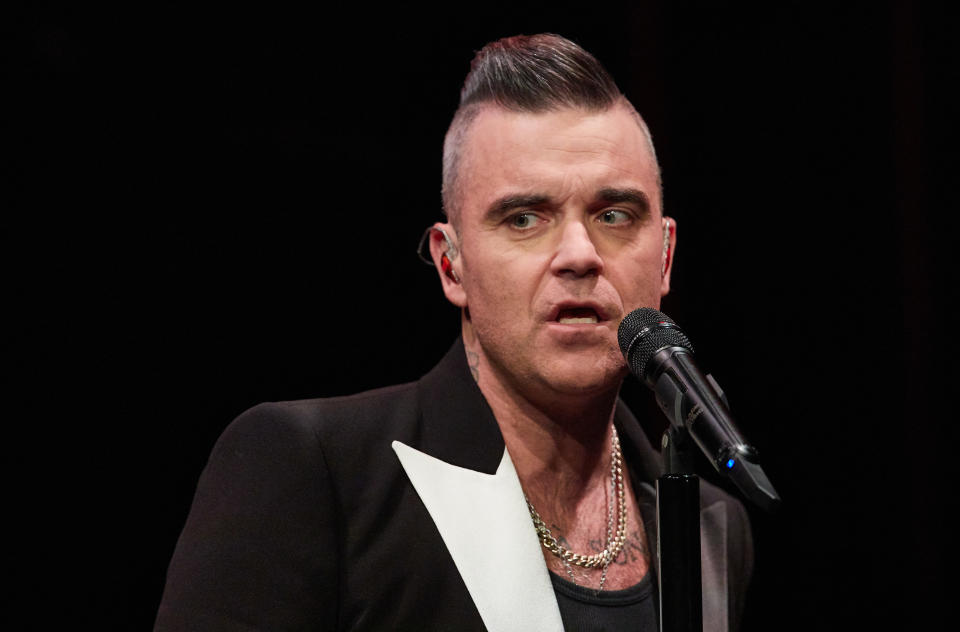 05 December 2019, Hamburg: The singer Robbie Williams stands on stage in the Kehrwieder Theater and gives a fan concert. Photo: Georg Wendt/dpa (Photo by Georg Wendt/picture alliance via Getty Images)