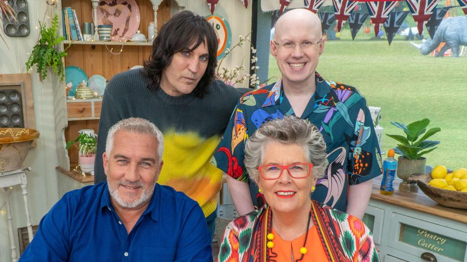 Matt Lucas smiling for a photo with Noel Fielding, Paul Hollywood and Prue Leith on The Great British Bake Off set