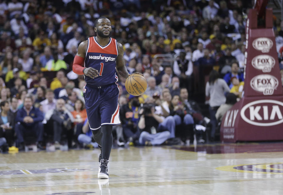 FILE - Washington Wizards' Will Bynum brings the ball up against the Cleveland Cavaliers in an NBA basketball game in Cleveland, in this Wednesday, April 15, 2015, file photo. Eighteen former NBA players, including Bynum, have been indicted on charges alleging they defrauded the league's health and welfare benefit plan out of about $4 million, according to an indictment Thursday, Oct. 7, 2021. (AP Photo/Mark Duncan, File)