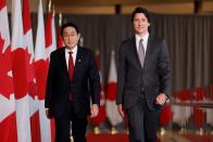 Canada's Prime Minister Justin Trudeau and Japanese Prime Minister Fumio Kishida arrive to a joint news conference in Ottawa
