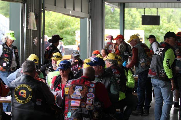 Riders gathered inside to eat pork sandwiches served by volunteers and other former riders.