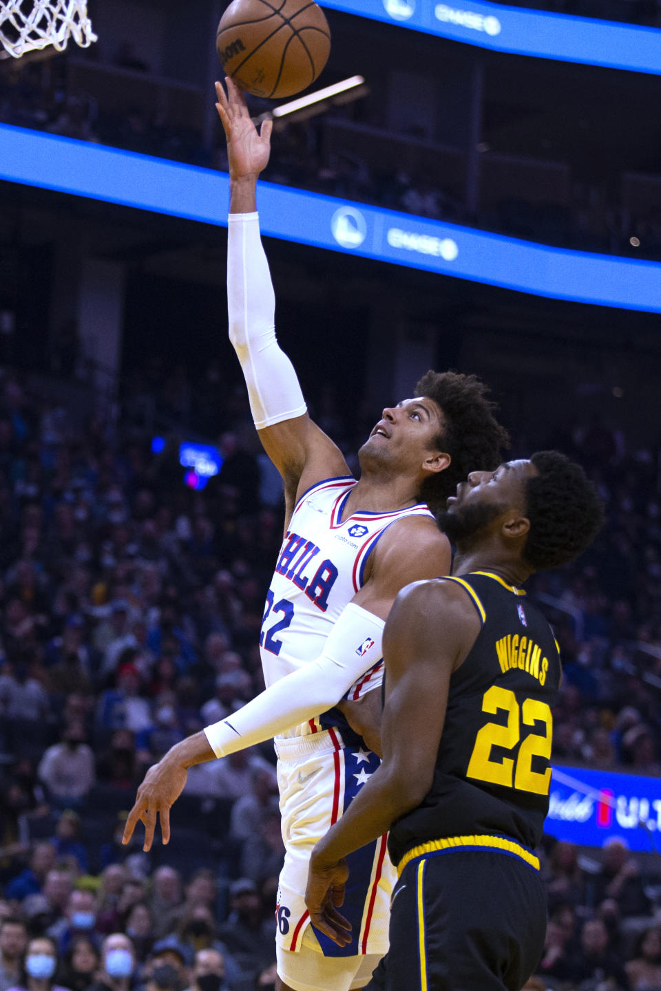 Philadelphia 76ers guard Matisse Thybulle (22) drives to the basket next to Golden State Warriors forward Andrew Wiggins (22) during the first quarter of an NBA basketball game Wednesday, Nov. 24, 2021, in San Francisco. (AP Photo/D. Ross Cameron)