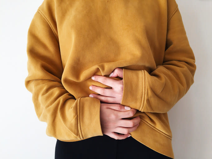 closeup of hands holding onto a stomach