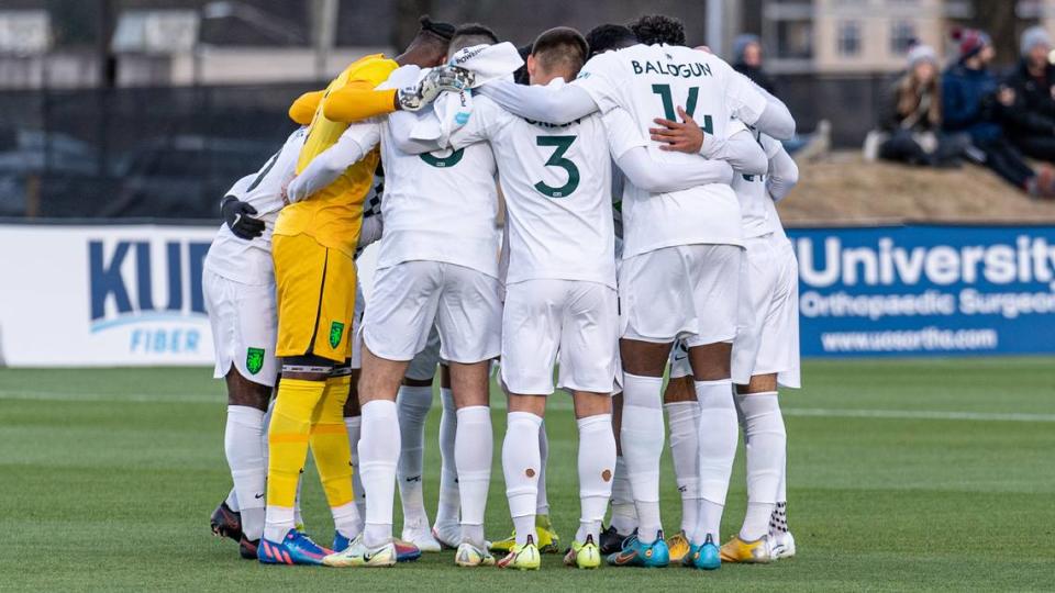 Lexington Sporting Club players gather in a huddle prior to the team’s first match in USL League One against One Knoxville SC at Regal Soccer Stadium in Knoxville, Tennessee, on Saturday.