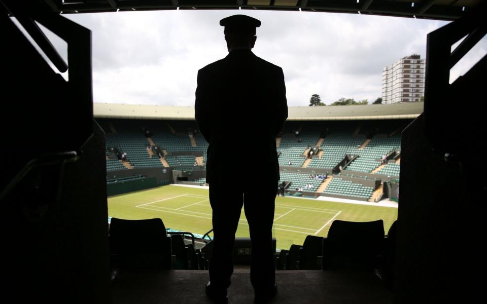 A security contractor looks out over court 1 at Wimbledon - GETTY IMAGES