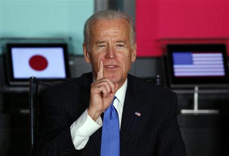 U.S. Vice President Joe Biden (L) gestures as he speaks to Japanese business leaders during their meeting at the headquarters of internet commerce and mobile games provider DeNA Co. in Tokyo December 3, 2013. REUTERS/Toru Hanai