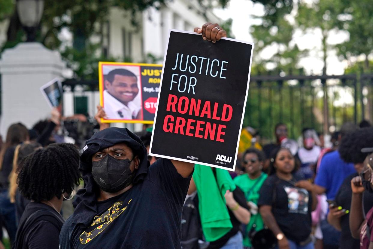 In this Thursday, May 27, 2021, file photo, demonstrators stand in front of the governor's mansion after a march from the state Capitol in Baton Rouge, La., protesting the death of Ronald Greene, who died in the custody of Louisiana State Police in 2019.