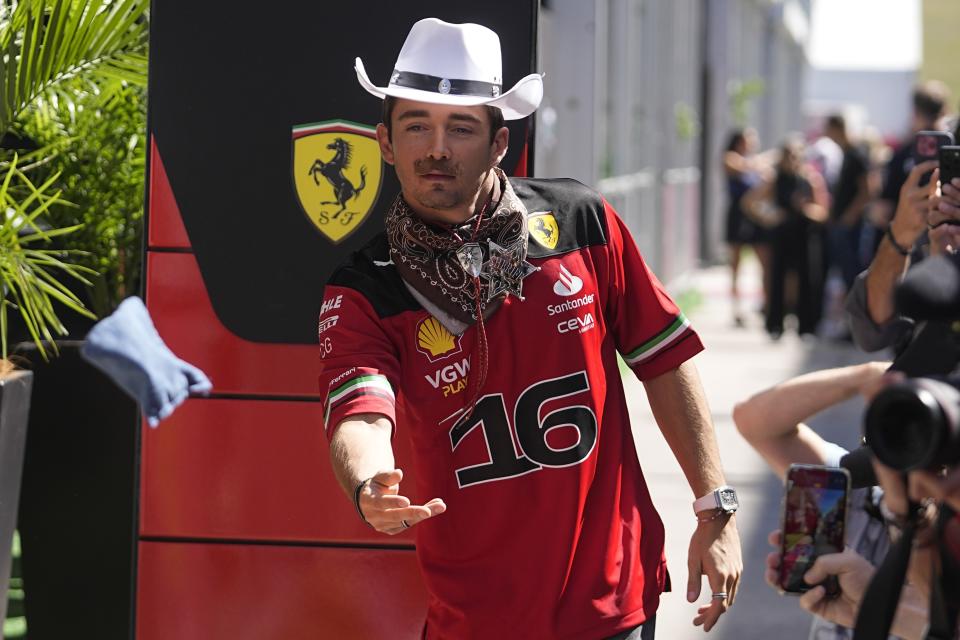 Ferrari driver Charles Leclerc, of Monaco, plays corn hole in the paddock at the Formula One U.S. Grand Prix auto race at Circuit of the Americas, Thursday, Oct. 19, 2023, in Austin, Texas. (AP Photo/Darron Cummings)