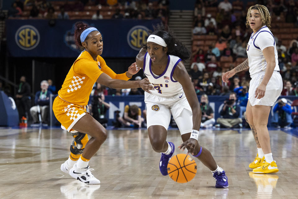 LSU's Flau'jae Johnson (4) drives to the basket against Tennessee's Jordan Walker (4) in the first half of an NCAA college basketball game during the Southeastern Conference women's tournament in Greenville, S.C., Saturday, March 4, 2023. (AP Photo/Mic Smith)