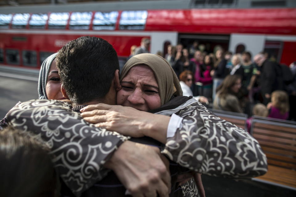 Houda, 48, hugs her son Ihab, 30, a Syrian migrant from Deir al-Zor, as he and his family arrive at the railway station in Lubeck, Germany September 18, 2015. Picture taken September 18, 2015.&nbsp;