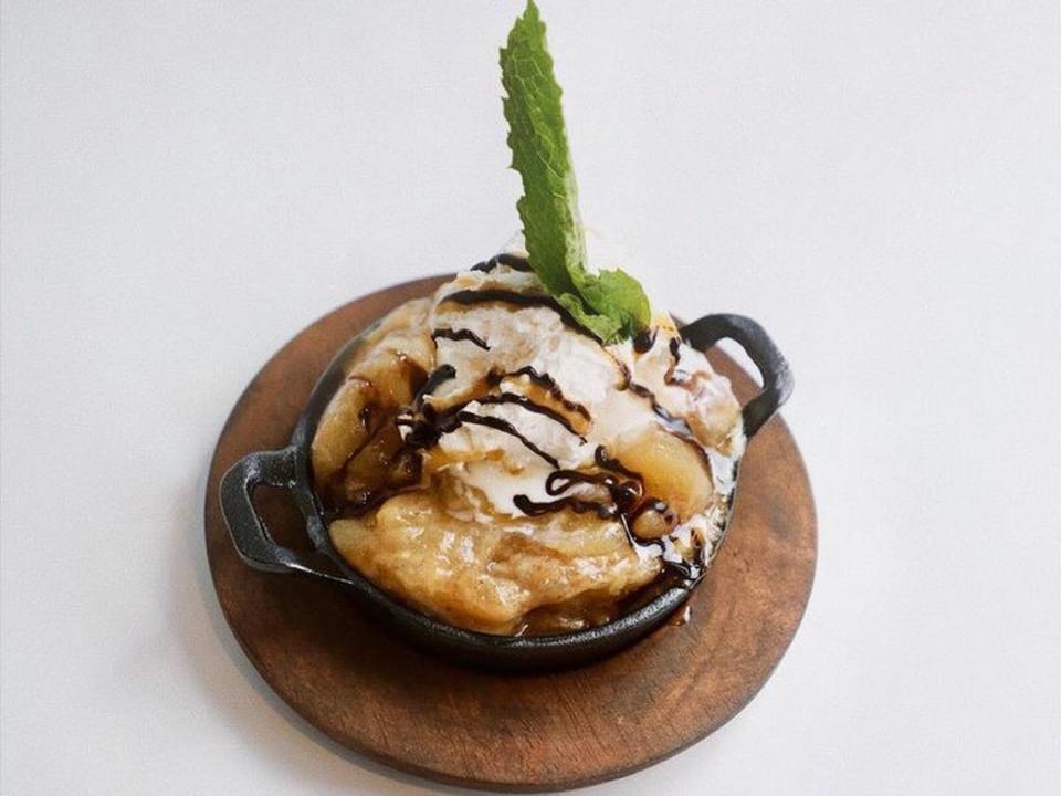 The apple dump cake from Salted Melon Market made with spiced apple pie filling, yellow cake, pecans and ice cream.